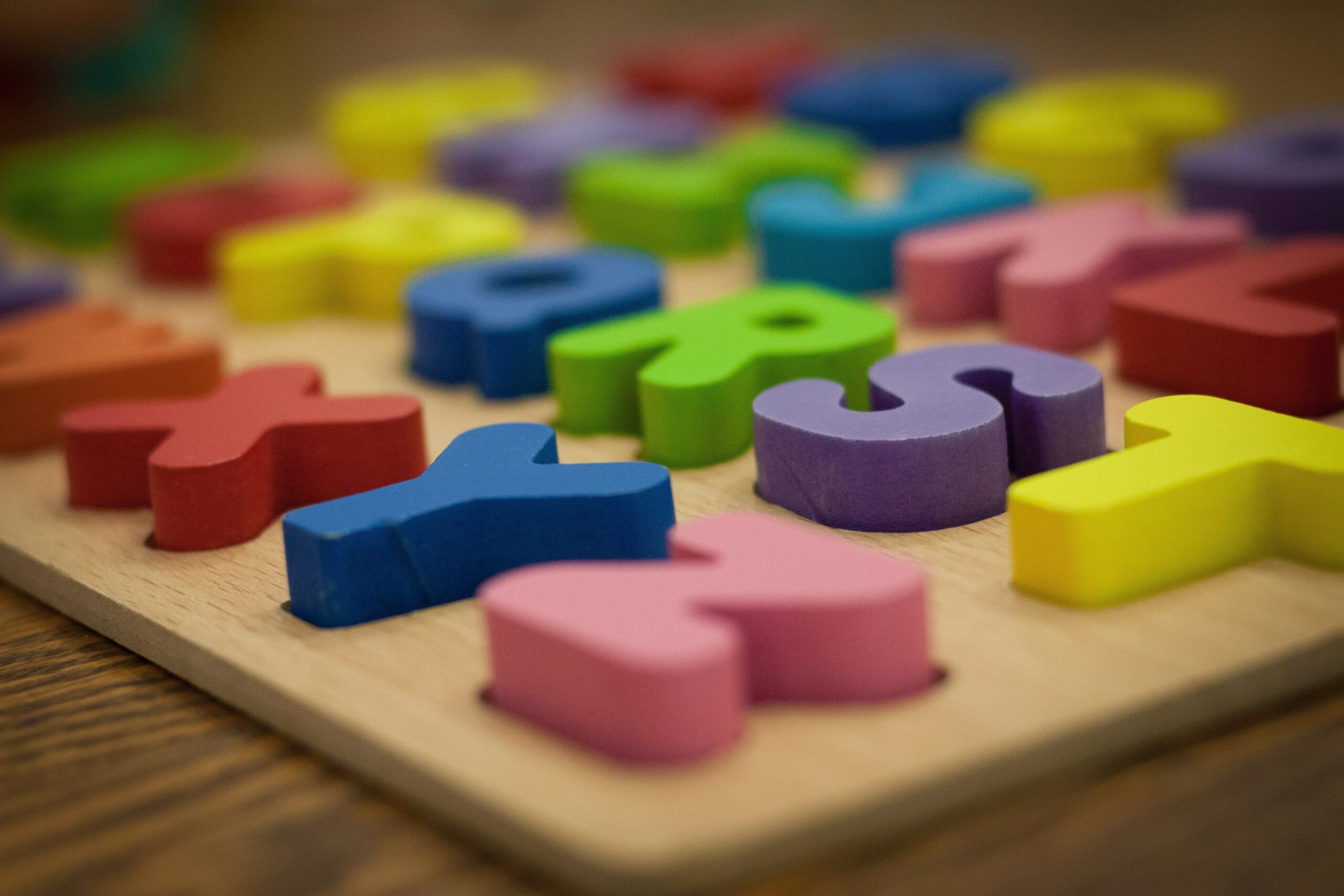 Angled view of brightly colored alphabet puzzle with large easy to grab pieces