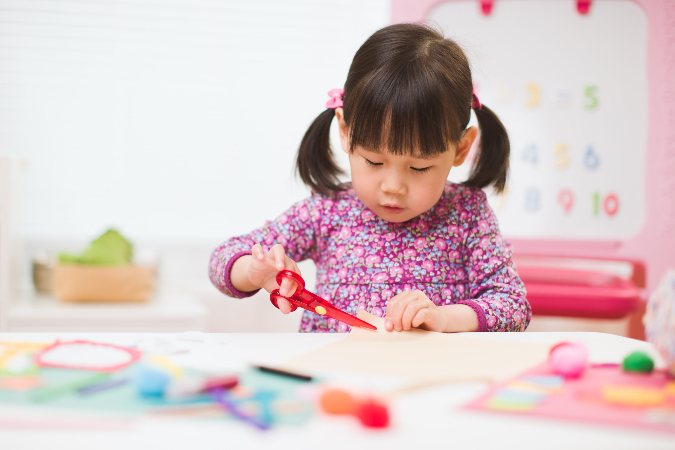 toddler girl  making craft for homeschooling