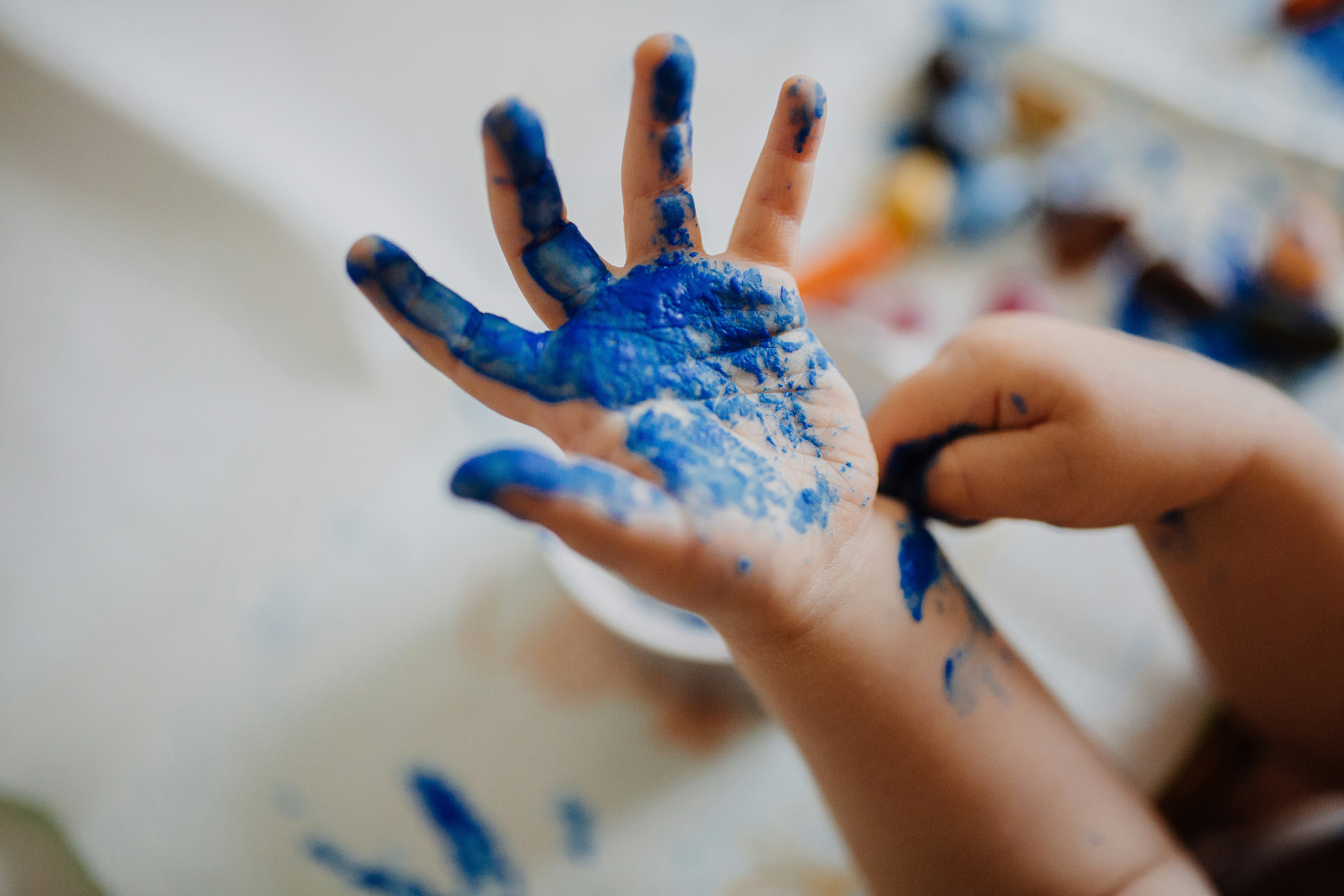 Blue paint on a child's hand